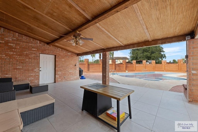 view of patio / terrace featuring ceiling fan and a fenced in pool