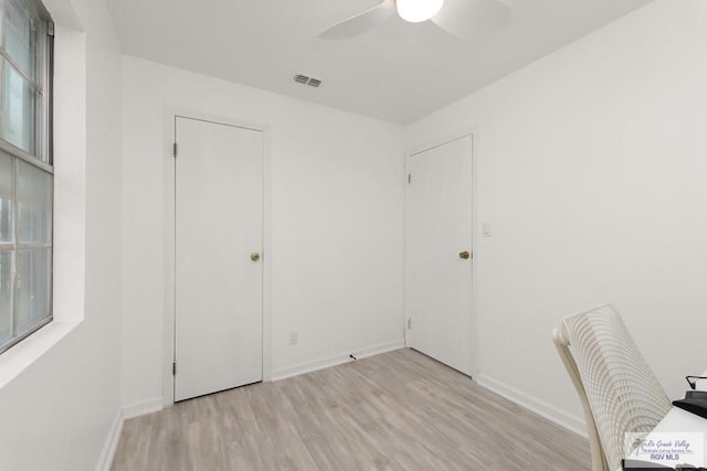 unfurnished office featuring ceiling fan and light wood-type flooring