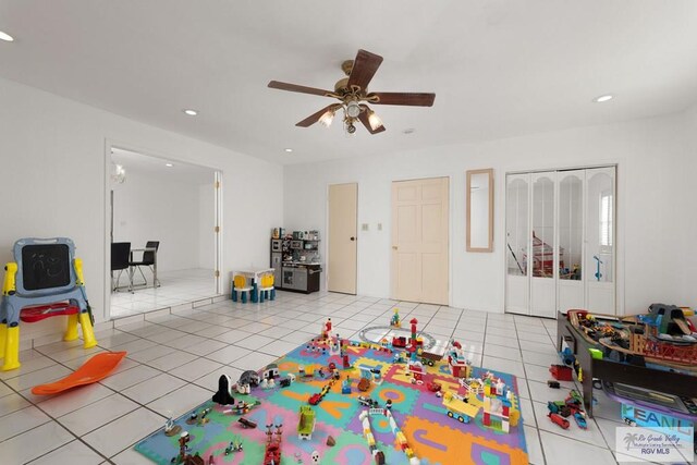 playroom with ceiling fan and light tile patterned floors