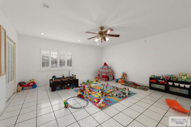 recreation room with ceiling fan and light tile patterned flooring