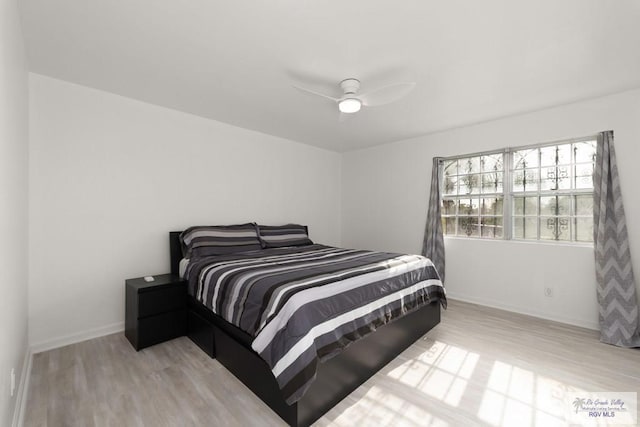 bedroom featuring ceiling fan and light hardwood / wood-style flooring