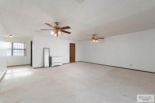 unfurnished room with ceiling fan, light colored carpet, and a textured ceiling