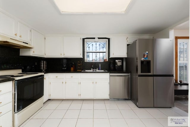 kitchen with light tile patterned floors, stainless steel appliances, white cabinetry, and sink