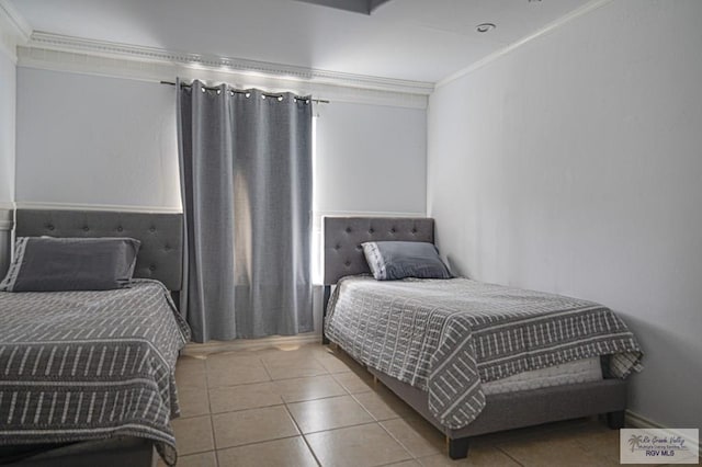 bedroom featuring ornamental molding and light tile patterned floors