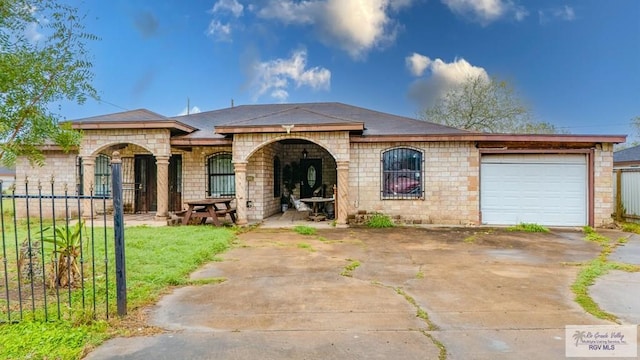 view of front facade with an attached garage, concrete driveway, and a front yard