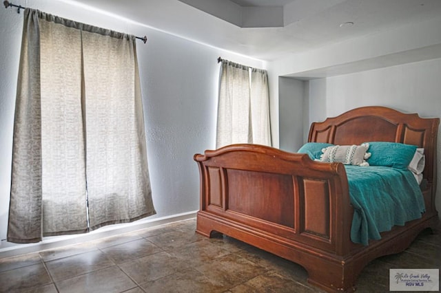 bedroom featuring baseboards