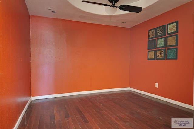 unfurnished room featuring a ceiling fan, hardwood / wood-style flooring, and baseboards