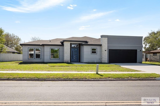 view of front of property featuring a front lawn and a garage