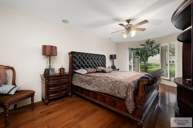 bedroom with ceiling fan and dark hardwood / wood-style flooring