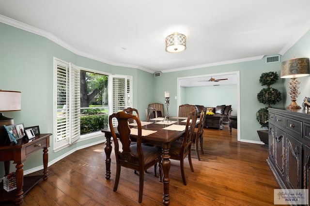 dining room with crown molding, ceiling fan, and dark wood-type flooring