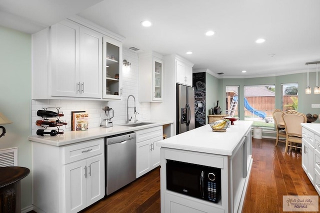 kitchen featuring white cabinets, appliances with stainless steel finishes, dark hardwood / wood-style floors, and sink