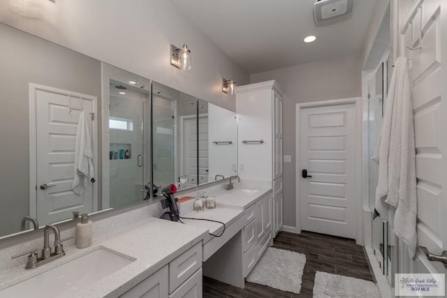 bathroom featuring wood-type flooring, vanity, and walk in shower