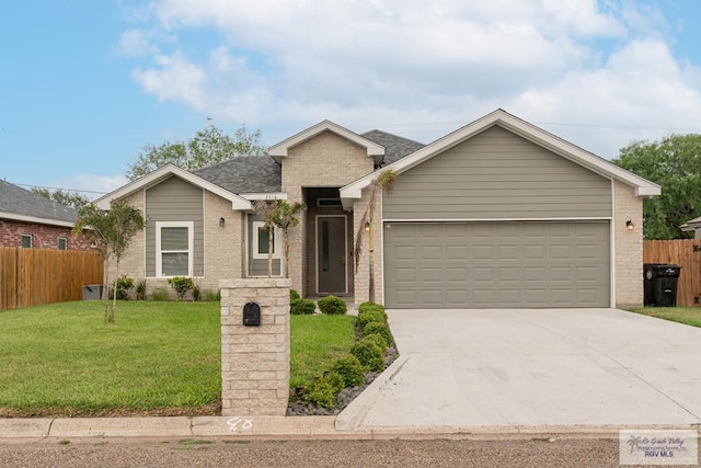 view of front of house with a front yard and a garage