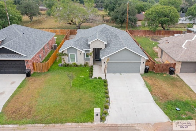 view of front of home with a front lawn and a garage