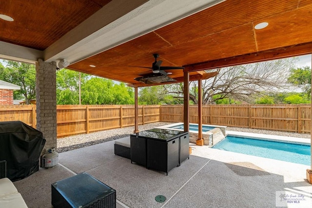 view of patio featuring a fenced in pool, area for grilling, and ceiling fan