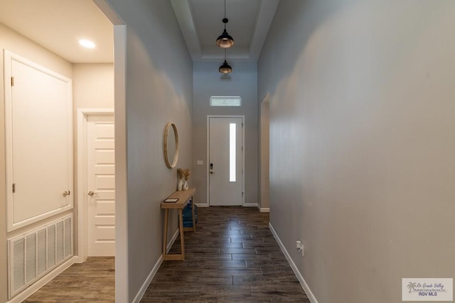 entryway with dark hardwood / wood-style flooring