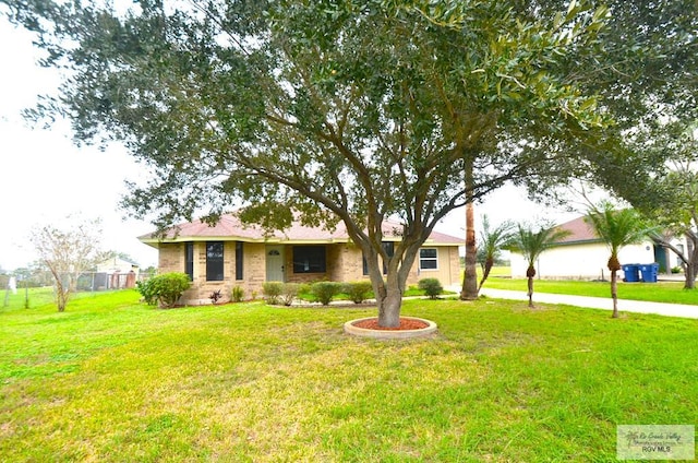 ranch-style home with a front lawn