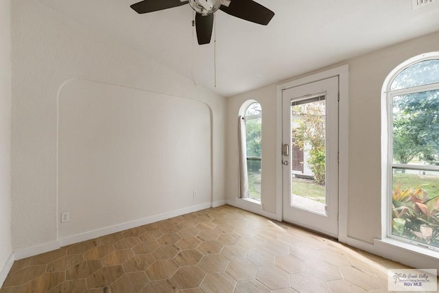 entryway with baseboards, lofted ceiling, and visible vents