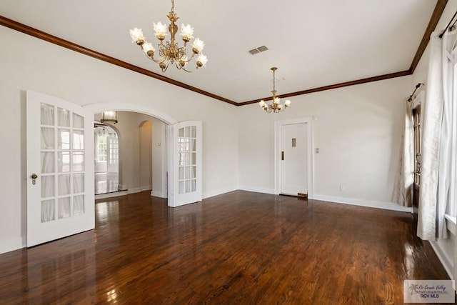 interior space with a notable chandelier, visible vents, arched walkways, and wood finished floors