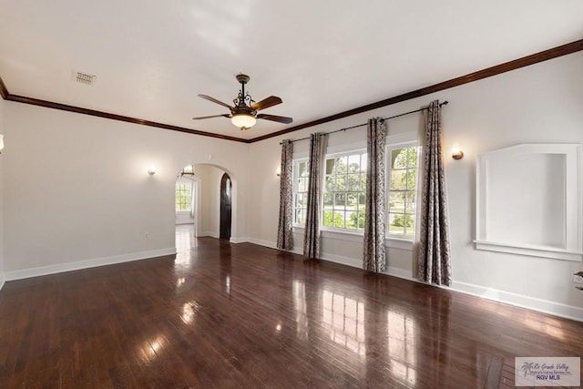 spare room with arched walkways, visible vents, plenty of natural light, and a ceiling fan