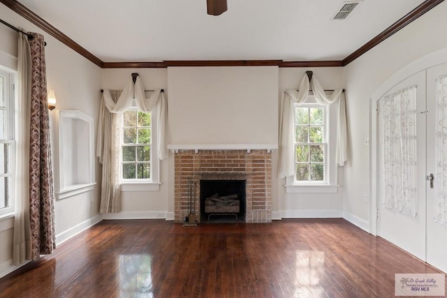 unfurnished living room with wood finished floors, visible vents, baseboards, french doors, and a brick fireplace