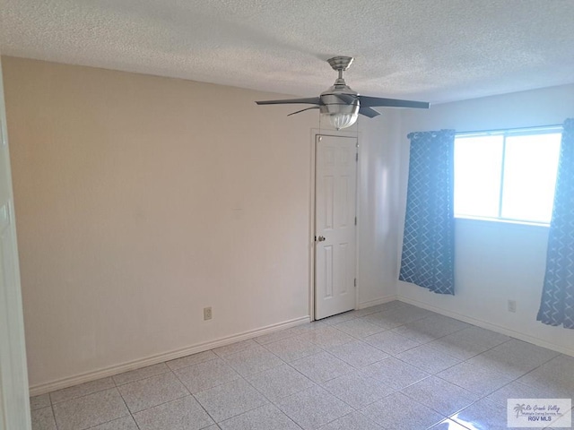 empty room featuring a textured ceiling and ceiling fan