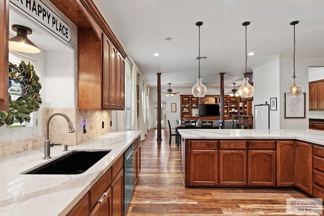 kitchen featuring dishwasher, sink, hanging light fixtures, ceiling fan, and decorative backsplash