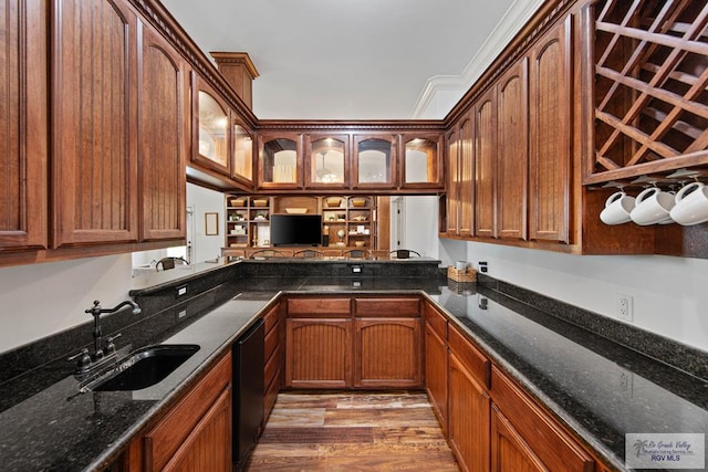 kitchen with kitchen peninsula, crown molding, sink, hardwood / wood-style floors, and black dishwasher