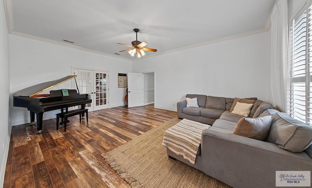 living room featuring dark hardwood / wood-style floors, a wealth of natural light, ornamental molding, and ceiling fan