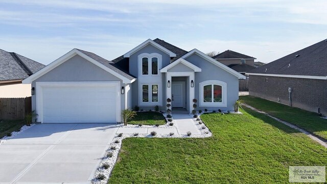 view of front facade with a garage, a front yard, concrete driveway, and stucco siding