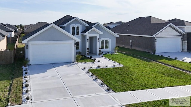 ranch-style home with a front lawn, driveway, and an attached garage