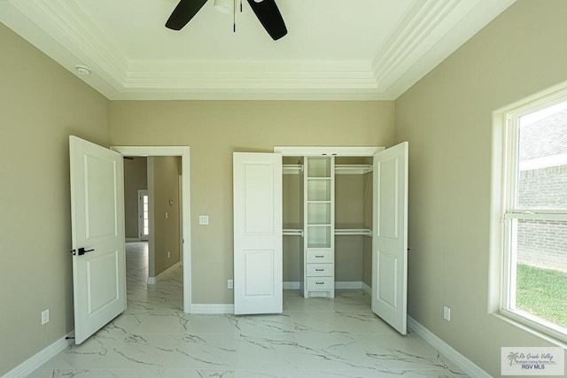 unfurnished bedroom featuring ornamental molding, marble finish floor, multiple windows, and baseboards