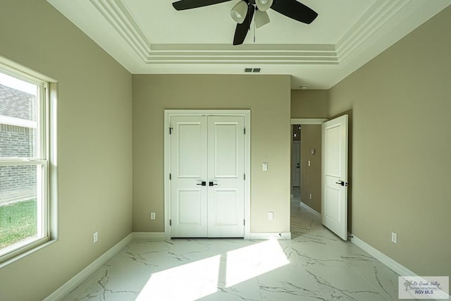 unfurnished bedroom featuring marble finish floor, a raised ceiling, visible vents, and baseboards