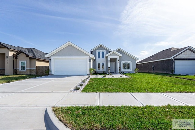 view of front of home with driveway, an attached garage, a front yard, and stucco siding