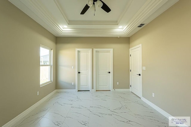 bedroom with visible vents, baseboards, marble finish floor, a tray ceiling, and crown molding