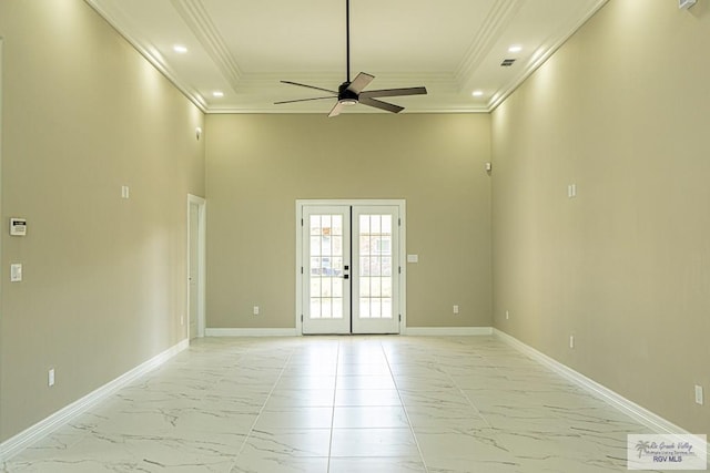 spare room featuring ornamental molding, marble finish floor, french doors, and baseboards