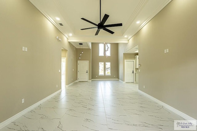 spare room with baseboards, marble finish floor, and crown molding