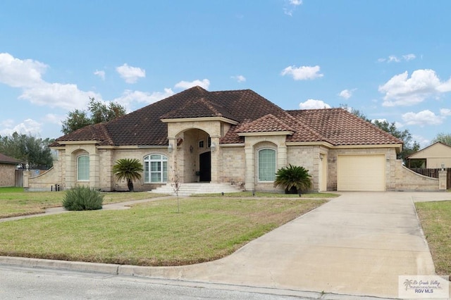 view of front of property featuring concrete driveway, an attached garage, a tiled roof, and a front lawn