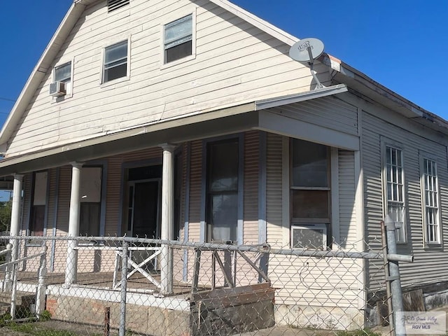 view of side of home with a porch