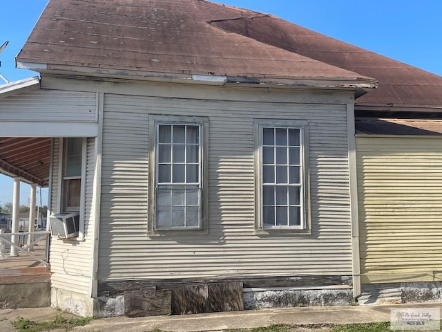 view of side of home featuring cooling unit