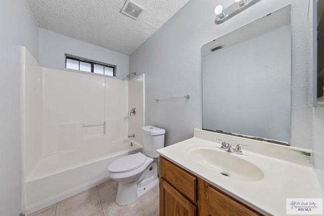 full bathroom with washtub / shower combination, tile patterned floors, a textured ceiling, toilet, and vanity