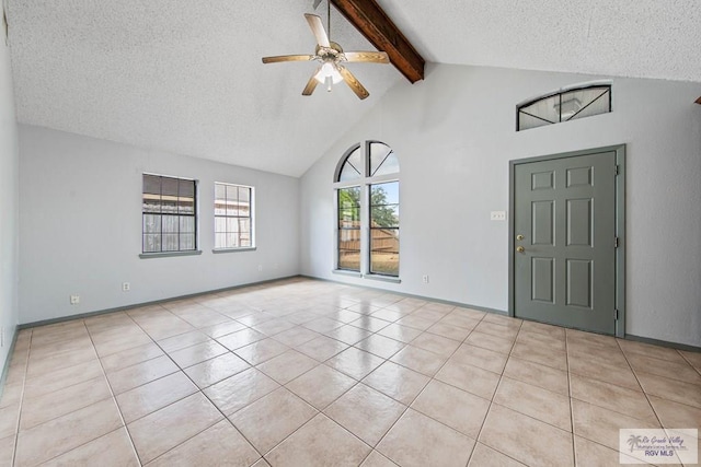 foyer with ceiling fan, beam ceiling, light tile patterned flooring, and a textured ceiling