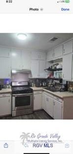 kitchen featuring white cabinets and stainless steel range oven