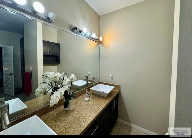 bathroom featuring vanity, tile patterned flooring, and baseboards