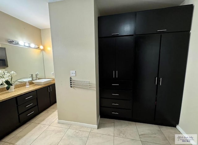 bathroom featuring baseboards and vanity