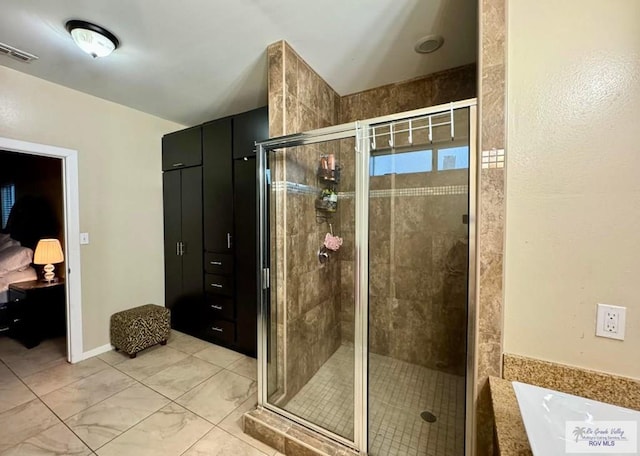 bathroom with visible vents, a stall shower, and a tub
