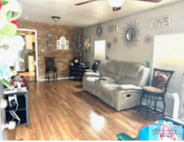 living room with hardwood / wood-style flooring and ceiling fan