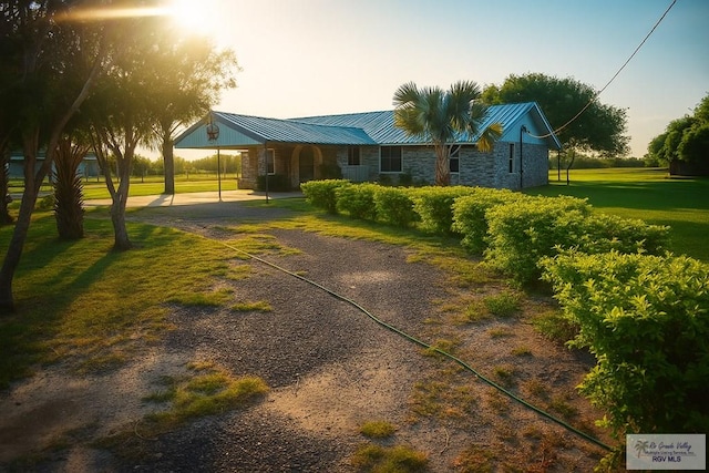 34719 Los Ranchos Rd Unit 1, San Benito, TX 78586 - ranch-style home with stone siding, a front lawn, a metal roof, and driveway