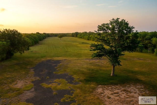 34719 Los Ranchos Rd Unit 1, San Benito, TX 78586 - nature at dusk featuring a rural view