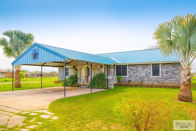 34719 Los Ranchos Rd Unit 1, San Benito, TX 78586 - single story home featuring a front lawn, a metal roof, and a carport